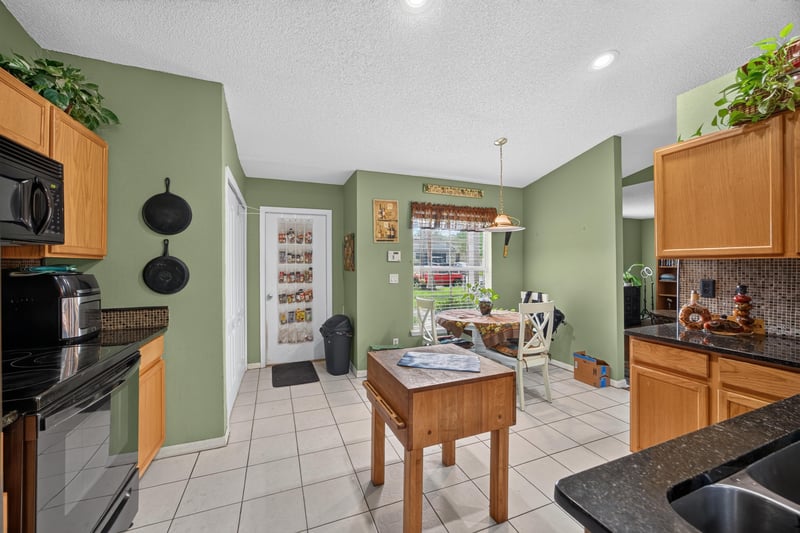 Kitchen view toward entry and dining area at 145 Dover Bluff Dr, Orange Park, FL