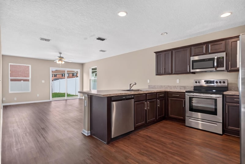 Kitchen wide view open to living space at 7253 Townsend Village Ct, Jacksonville, FL