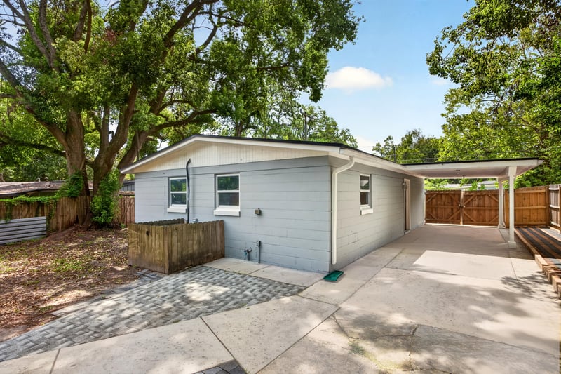 Exterior view with carport and yard at 7015 Miss Muffet Ln N, Jacksonville, FL 32210