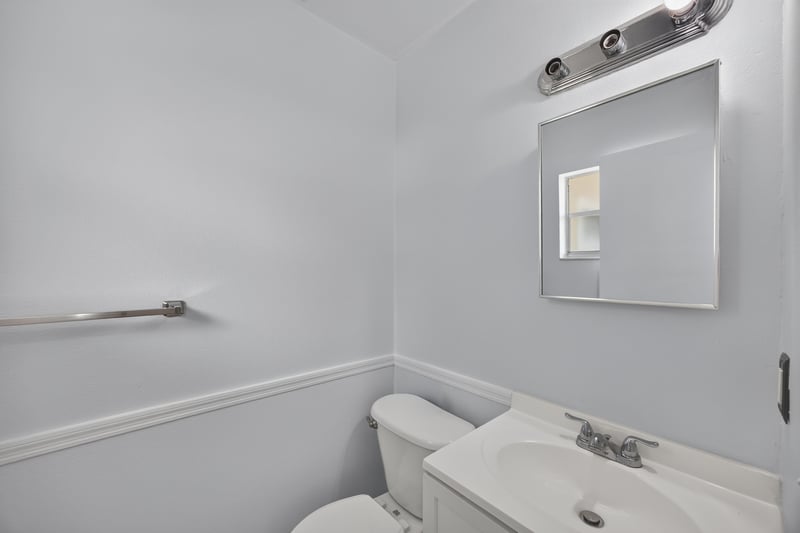 Bathroom with grab bar, toilet, and sink at 328 Palos Ct, St. Augustine, FL