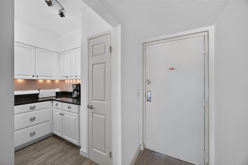 Kitchen cabinets and entry door at 601 1st St S, Jacksonville Beach