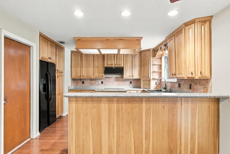 Kitchen counter with black refrigerator at 2915 Trenton Ct, Orange Park, FL