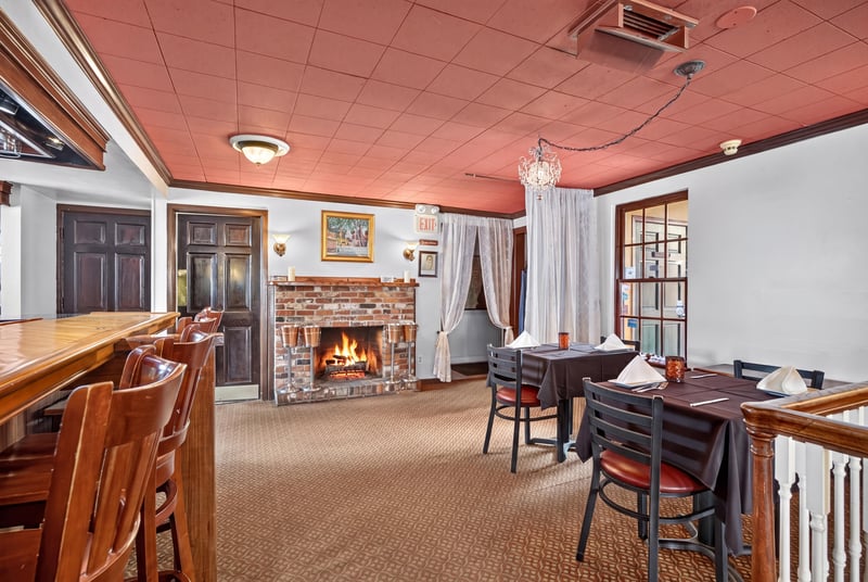 Dining area with fireplace and red ceiling at 115 Cordova St, St. Augustine, FL