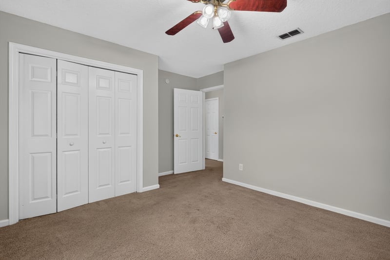 Empty carpeted room with closet doors at 11669 Collins Creek Dr, Jacksonville, FL 32258