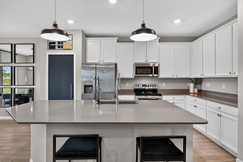 Kitchen island with pendant lighting and bar seating at 9942 Lovage Ln, Jacksonville, FL 32219