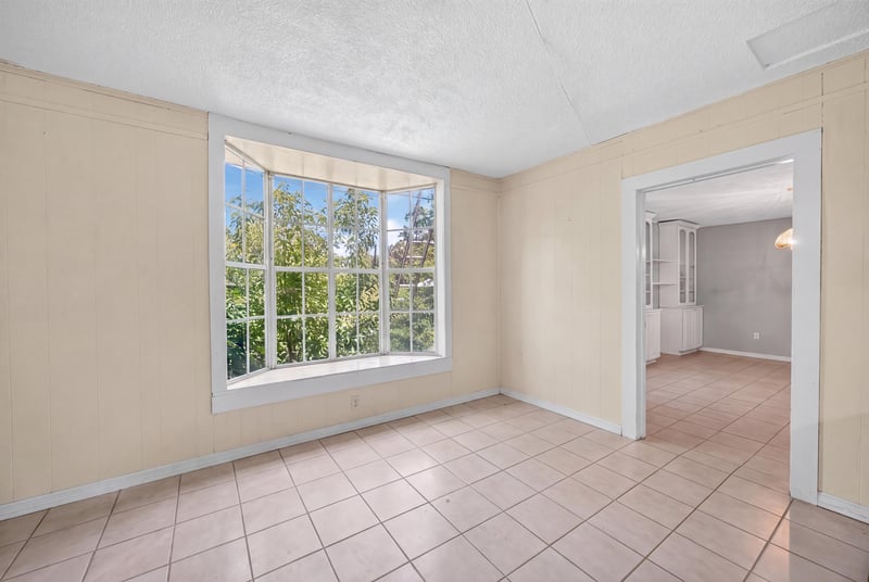 Unfurnished room with tile floor and window at 1173 US-17, Satsuma, FL 32189
