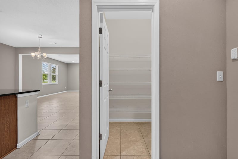 Hallway near kitchen with pantry door and tile floor at 263 Gilmore Ln, Orange Park, FL 32065