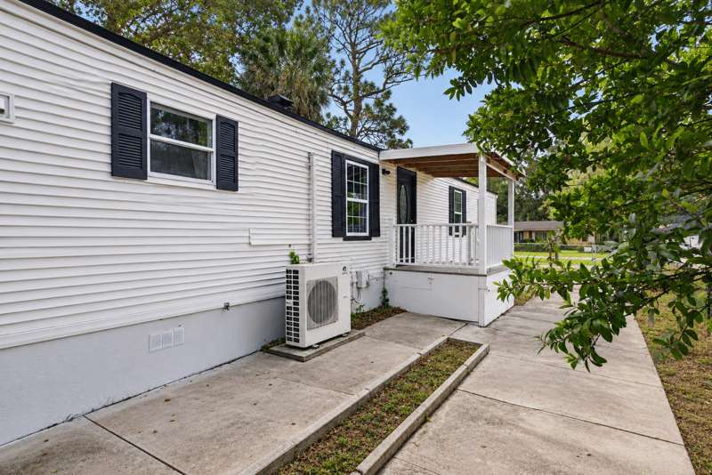 Side exterior view with covered porch and AC unit at 4565 Appleton Ave, Jacksonville, FL