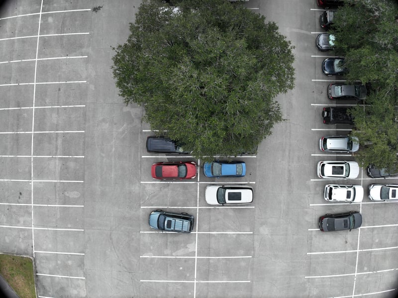 Aerial view of parking lot with landscaped tree island at 9406 Atlantic Blvd, Jacksonville, FL 32225