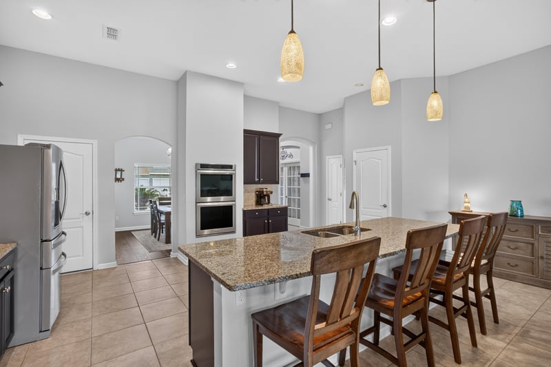 Kitchen island with dishwasher and granite counters at 538 Porta Rosa Circle, St. Augustine, FL 32092