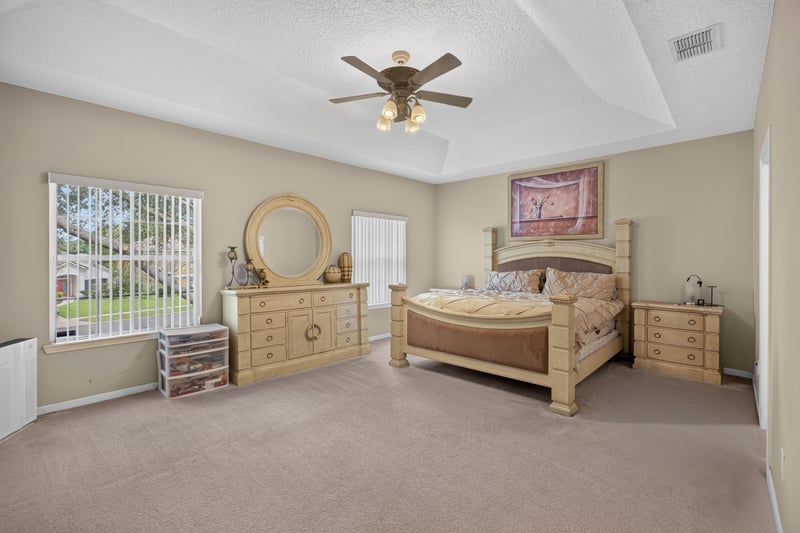 Bedroom with dresser and ceiling fan at 2875 Pebblewood Ln, Orange Park, FL 32065