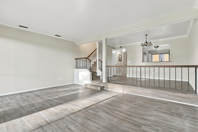 Living room with staircase and railing at 7703 Las Palmas Way