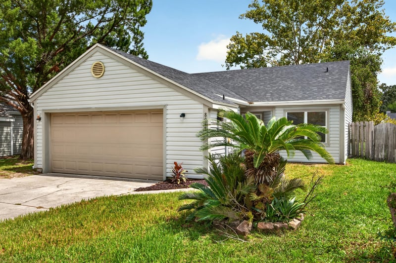 Front exterior close-up of entry and landscaping at 8047 Mactavish Way E, Jacksonville, FL 32244