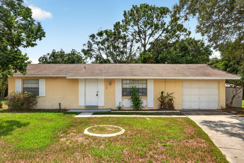 Front exterior view of the single-story home and driveway at 328 Palos Ct, St. Augustine, FL