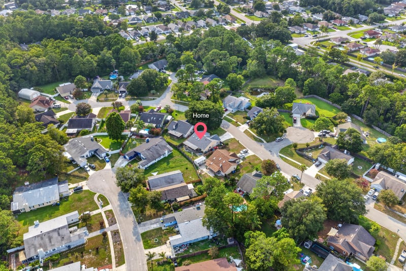 Aerial neighborhood view with rooftops and trees in Jacksonville, FL