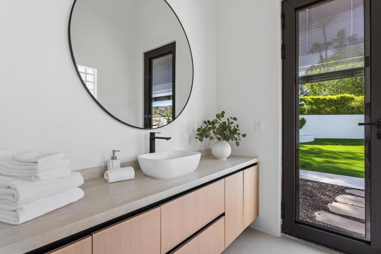 Guest bath with floating white oak vanity and stone basin, Paradise Valley