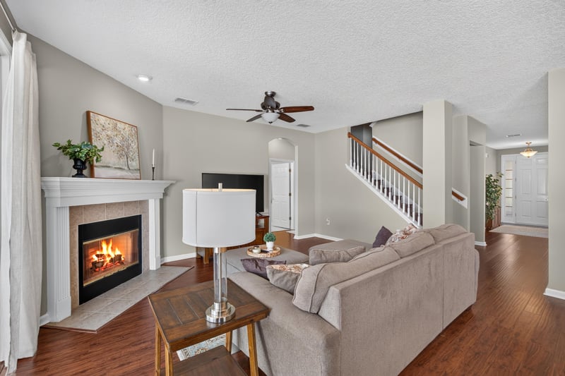 Living room with stone fireplace and staircase at 3660 Middlebrook Dr, Orange Park, FL 32065