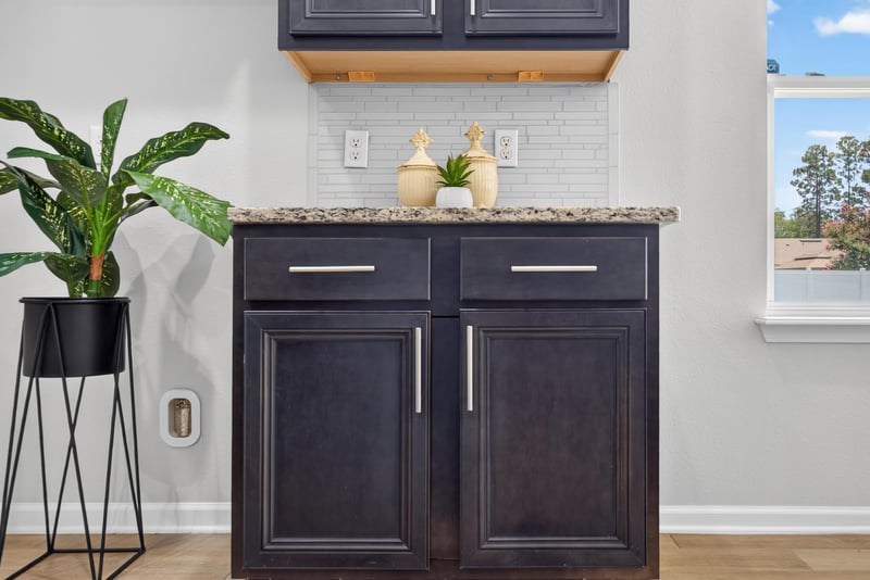Kitchen counter with tile backsplash and window at 10066 Andean Fox Dr, Jacksonville, FL 32222