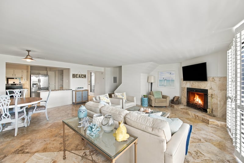 Living and dining area with fireplace and beach decor at 752 Spinnakers Reach Dr, Ponte Vedra Beach, FL 32082