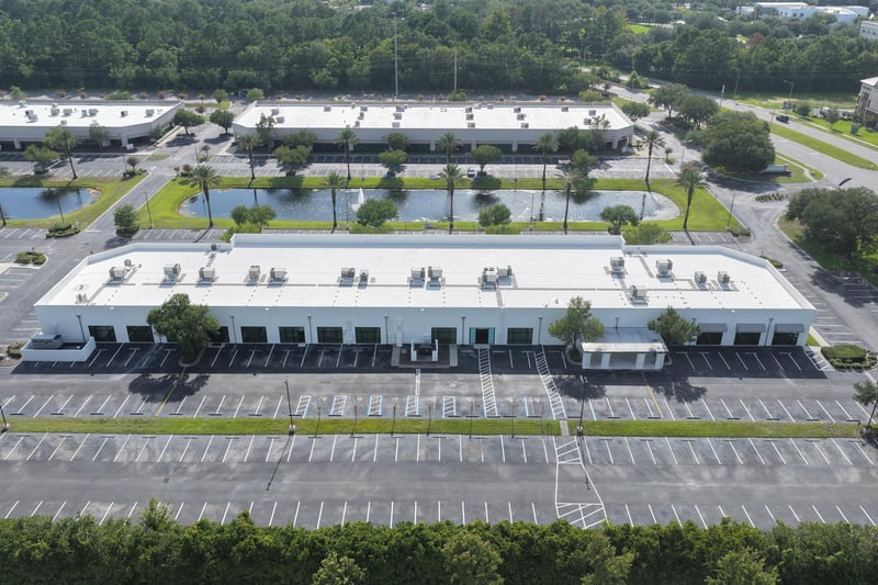 Aerial view of a long roofline with ponds and parking lots at 10550 Deerwood Park Blvd, Jacksonville, FL 32256