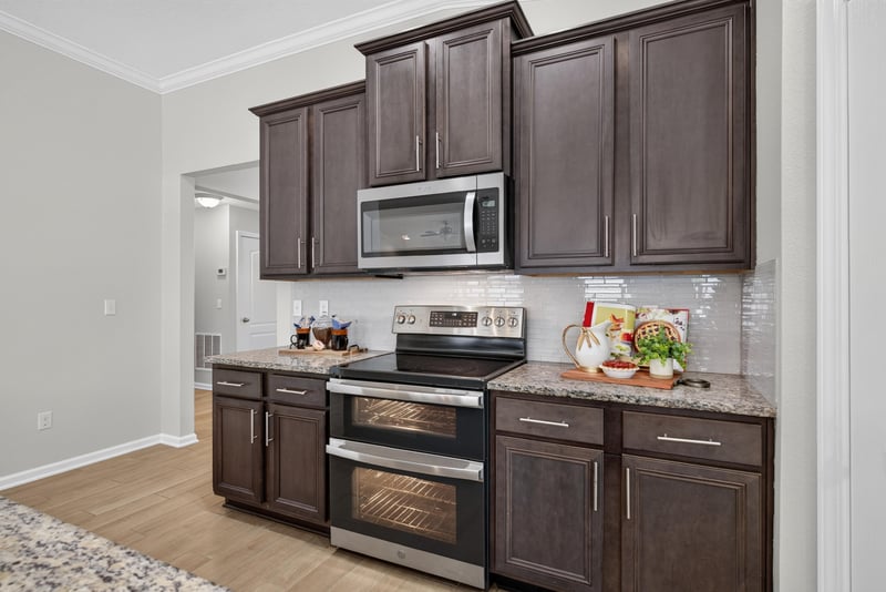 Kitchen stove and cabinetry with granite counters at 10066 Andean Fox Dr, Jacksonville, FL 32222