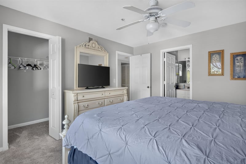 Primary bedroom with bed and television on dresser at 206 16th St, St. Augustine, FL 32080