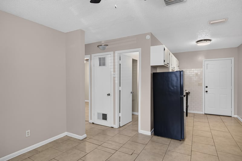 Kitchen area with black refrigerator and tile floor at 8067 Parental Cir, Jacksonville, FL 32216