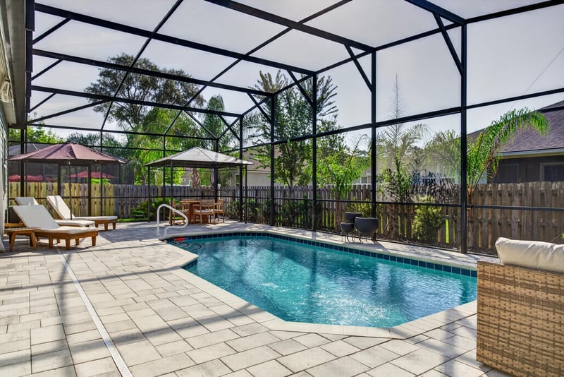 Screened pool enclosure with paver patio at 3328 Southern Oaks Dr, Green Cove Springs, FL 32043