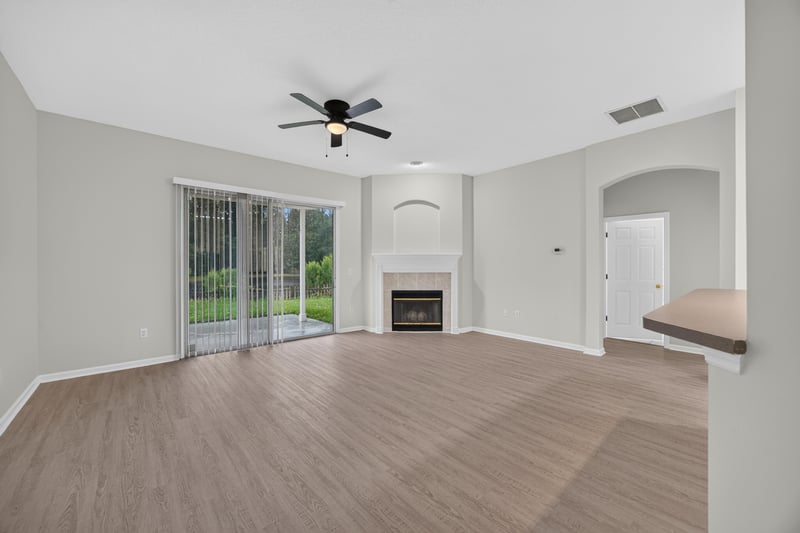 Living room with fireplace and sliding glass door at 706 Bonaparte Dr, Jacksonville, FL 32218