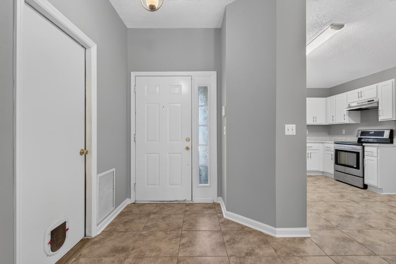 Entry hall with front door and view toward kitchen at 1108 Hidden Cove Cir S, Atlantic Beach, FL 32233