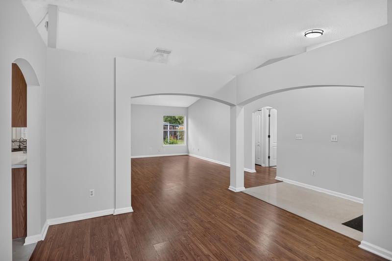 Open living space with arched openings and wood floors at 9691 Nelson Forks Dr, Jacksonville, FL 32222
