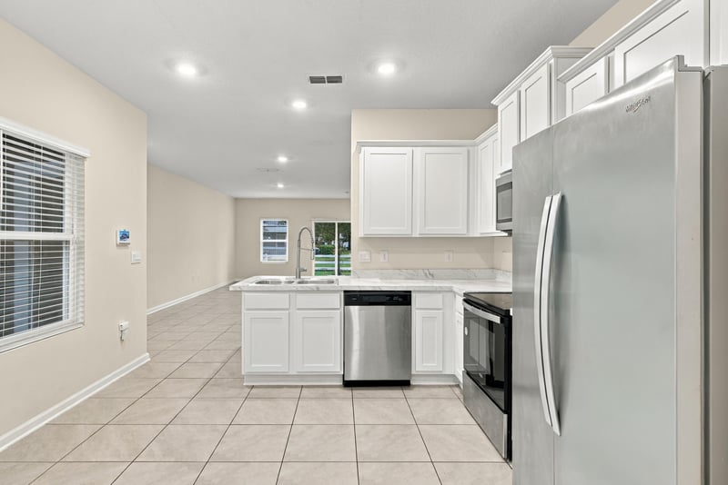 Kitchen with stainless refrigerator and tile floor at 9555 Star Dr, Jacksonville, FL 32256