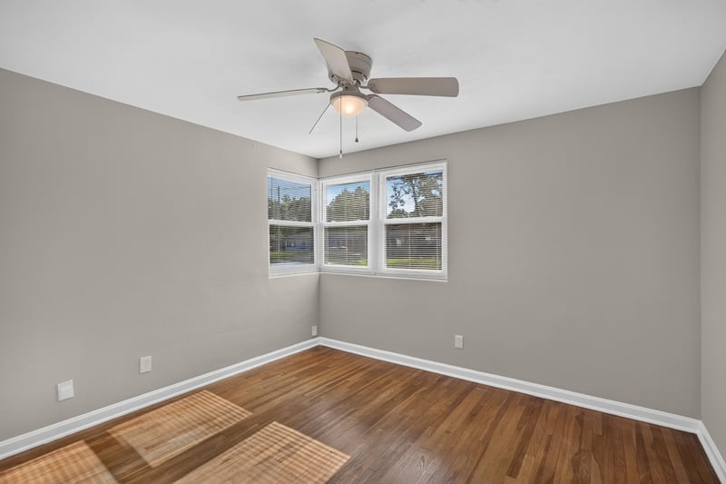 Bedroom with windows and hardwood floors at 6338 Mercer Cir W, Jacksonville, FL