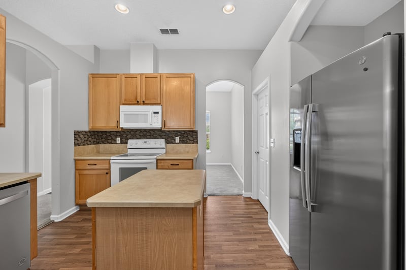 Kitchen with white appliances and center island at 2480 Ridge Will Dr, Jacksonville, FL 32246