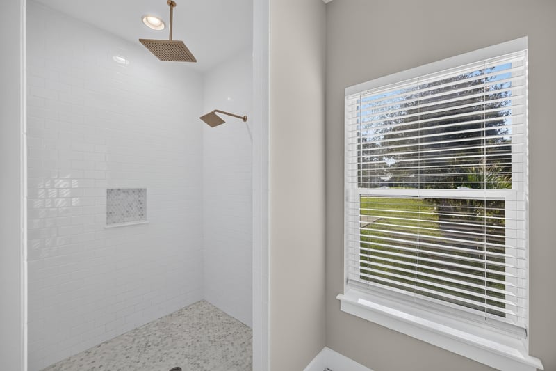 Tiled shower stall with window at 175 Alava Ct