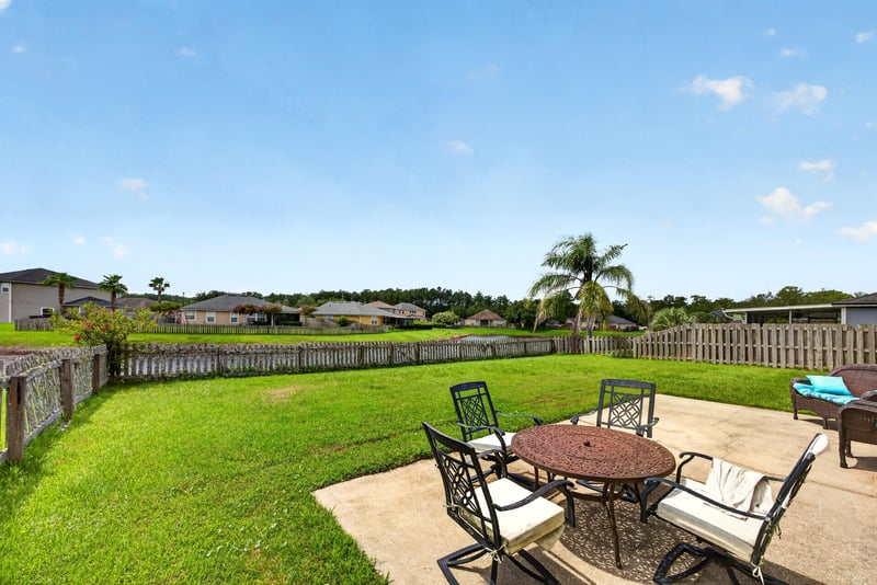 Backyard patio with table and fenced yard at 2065 Creekmont Dr