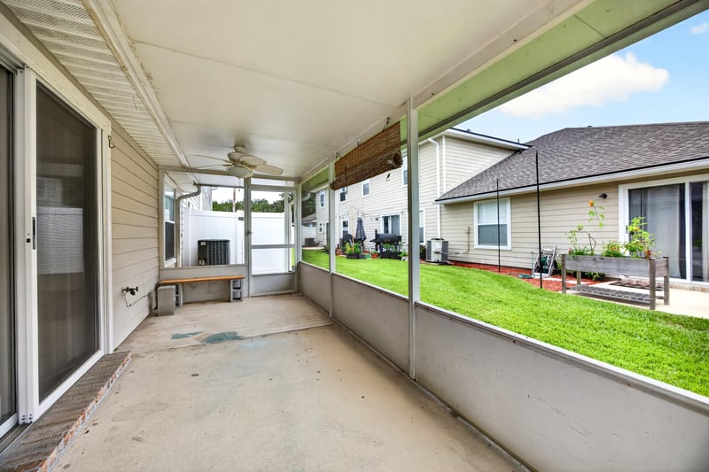 Covered rear porch with concrete floor at 605 N Covered Bridge Rd, Jacksonville, FL