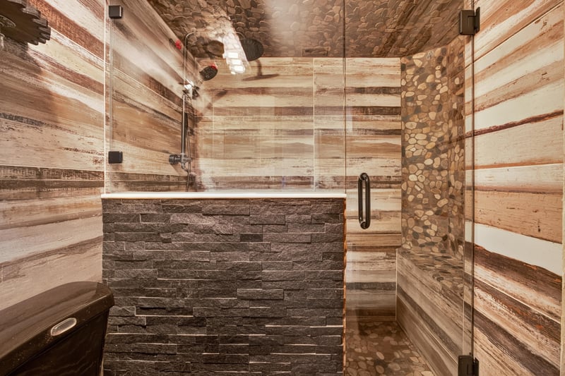 Bathroom shower with stone tile at 6931 Cane Grass Ln E, Jacksonville, FL 32244