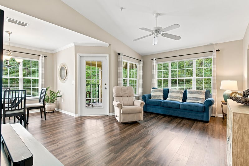Living room with vaulted ceiling and sliding glass doors at 7800 Point Meadows Dr, Jacksonville, FL 32256