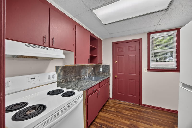 Kitchen with granite-look counters and red cabinets at 2132 Allandale Cir W, Jacksonville, FL