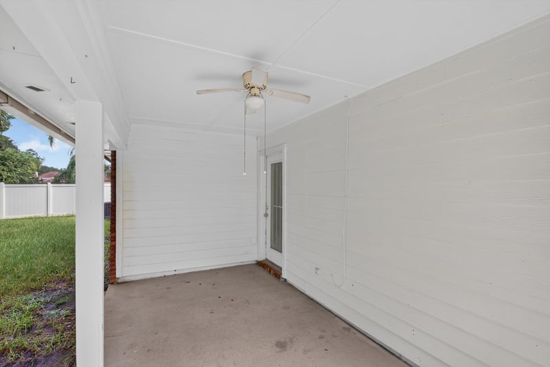 Covered back porch with ceiling fan at 11669 Collins Creek Dr, Jacksonville, FL 32258