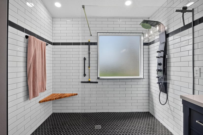 Primary bathroom shower with subway tile and black hex floor at 2065 Creekmont Dr