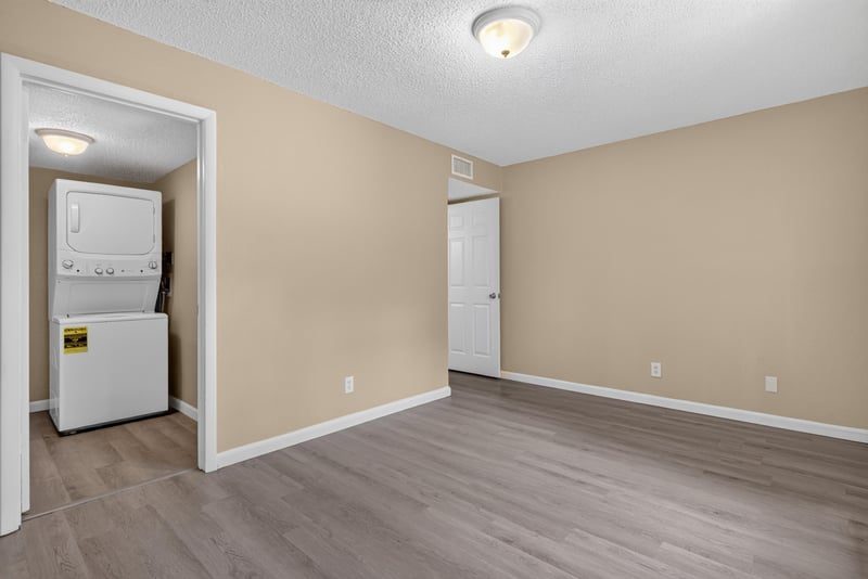 Laundry closet with stacked washer and dryer at 5811 Atlantic Blvd unit 47, Jacksonville, FL 32207