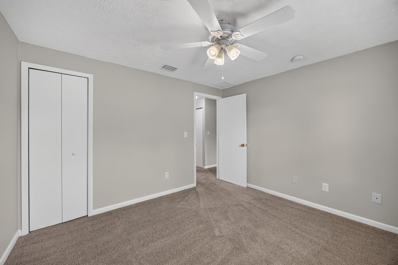 Bedroom with closet doors and carpet at 1143 Tumbleweed Dr, Orange Park, FL 32065
