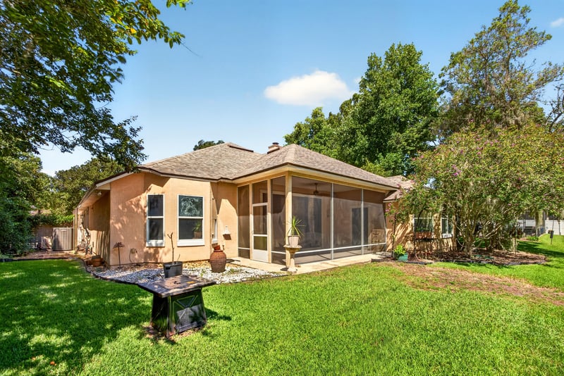 Backyard with screened porch and pond at 11675 Magnolia Estates Rd, Jacksonville, FL 32223