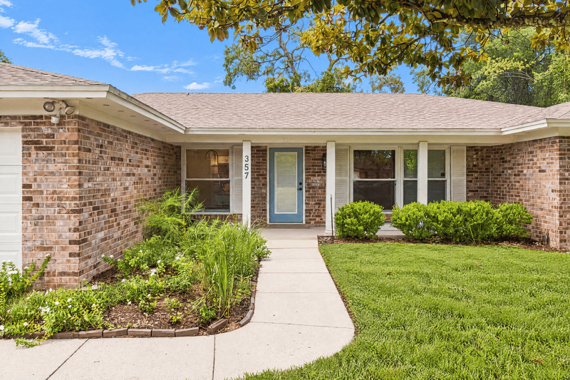 Front entry with blue door and brick facade at 357 Dillon Dr, Orange Park, FL