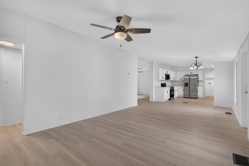 Hallway view toward kitchen with wood floor at 55520 Jewel-Thomas Rd, Callahan, FL 32011