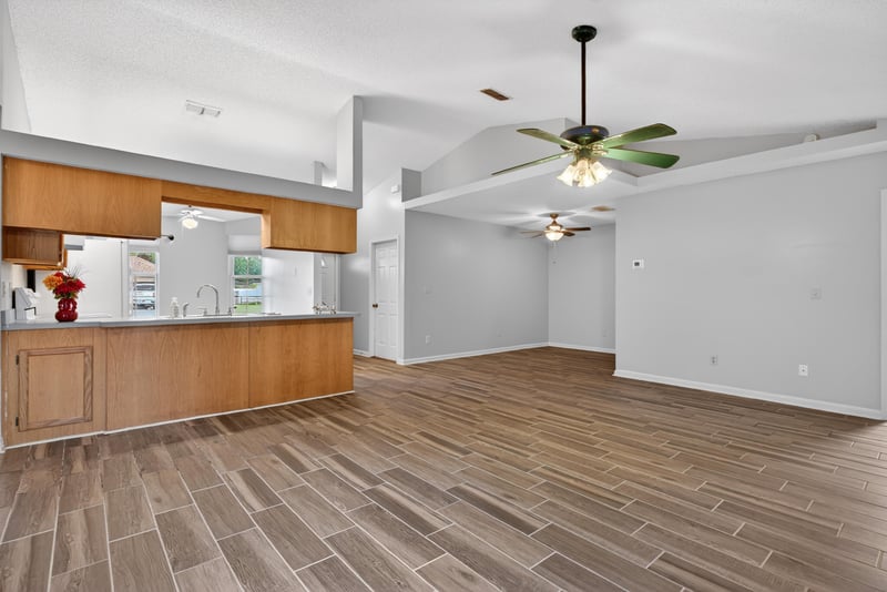 Open living and dining area with wood-look floor at 2164 Orangewood St, Middleburg, FL 32068