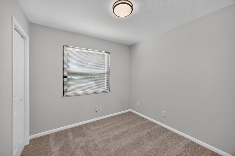 Empty carpeted room with window at 7453 Jade Dr N, Jacksonville, FL 32210