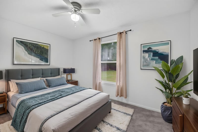 Bedroom with bed and ceiling fan at 8921 Needlepoint Pl, Jacksonville, FL 32244